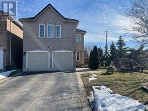 Mississauga (Meadowvale) apartment for rent - A house with a driveway in front of it.