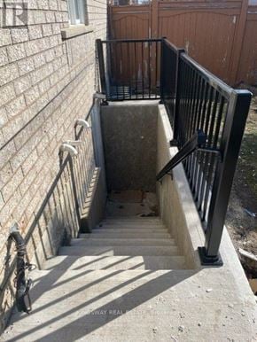 Mississauga (Meadowvale) apartment for rent - A staircase with a black railing and a stone step.