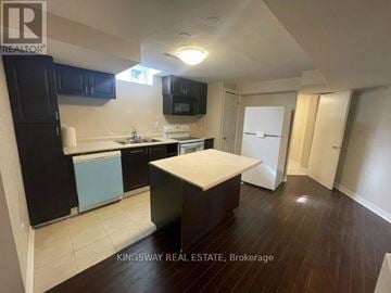 Mississauga (Meadowvale) apartment for rent - A kitchen with a white countertop and black cabinets.