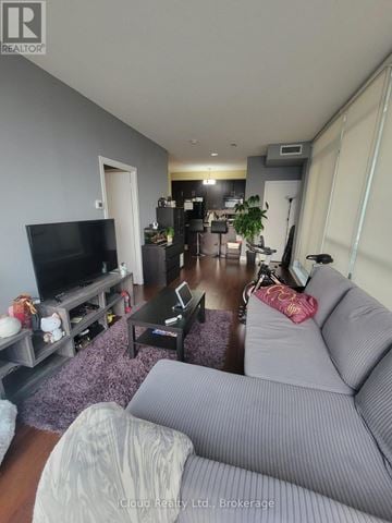 Mississauga (Creditview) condo for rent - A living room with a grey couch and a television.