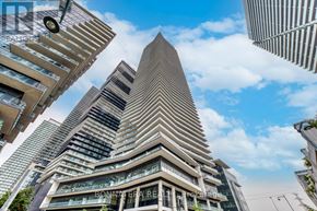 Toronto (Mimico) condo for rent - A tall building with a triangular top is the focal point of the image.