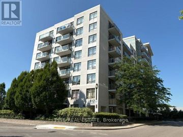 Toronto (Dovercourt-Wallace Emerson-Junction) condo for rent - A tall residential building with balconies and a sign that reads "Pine Real Estate Brokerage.".