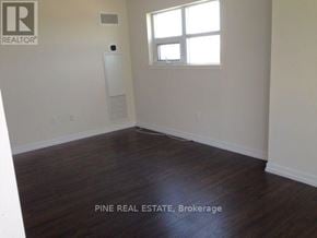 Toronto (Dovercourt-Wallace Emerson-Junction) condo for rent - A room with wood flooring and a window is for sale.