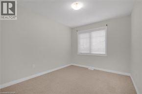 Beamsville townhouse for rent - A room with a window and carpeted floor.