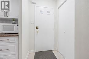 Waterloo townhouse for rent - A white door with a gold handle is in a white room.