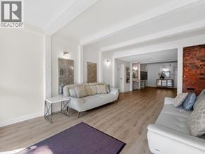 North Vancouver apartment for rent - A living room with a white couch and a purple rug.