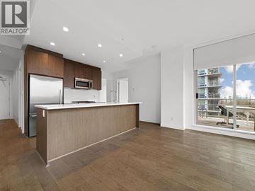 Burnaby apartment for rent - A modern kitchen with wooden cabinets and a large island.