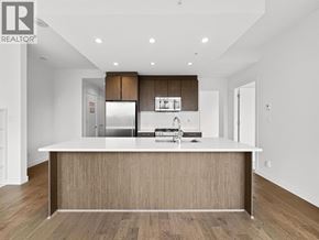 Burnaby apartment for rent - A modern kitchen with a large island and wooden cabinets.