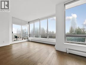 Burnaby apartment for rent - A large, empty room with a view of trees outside the windows.