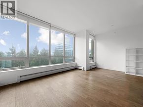 Burnaby apartment for rent - A large, empty room with wooden floors and large windows.