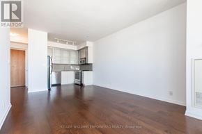 Toronto (Church-Yonge Corridor) condo for rent - A spacious kitchen with white walls and wooden floors.