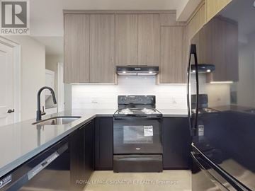 Toronto (Little Portugal) apartment for rent - A modern kitchen with a black stove top oven.