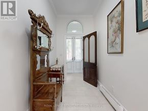 Toronto (Little Portugal) apartment for rent - A hallway with a wooden bench and a mirror on the wall.