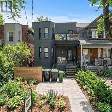 Toronto (South Parkdale) apartment for rent - A grey house with a small garden in front.