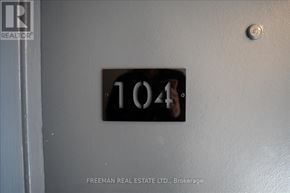 Toronto (South Parkdale) apartment for rent - A door with a number 104 on it and a Freeman Real Estate Ltd. logo.