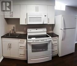 Oakville (Wt West Oak Trails) apartment for rent - A white kitchen with a stove, oven, microwave, and refrigerator.