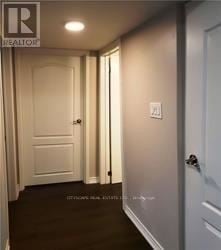 Oakville (Wt West Oak Trails) apartment for rent - A hallway with a door on the right and a light switch on the wall.