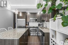 Toronto (Edenbridge-Humber Valley) condo for rent - A modern kitchen with a marble countertop and stainless steel appliances.