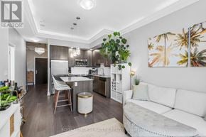 Toronto (Edenbridge-Humber Valley) condo for rent - A well-lit kitchen with a breakfast bar and a dining table with chairs.