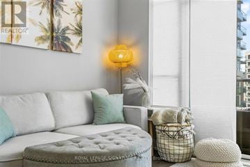 Toronto (Edenbridge-Humber Valley) condo for rent - A living room with a white couch and a yellow lamp.