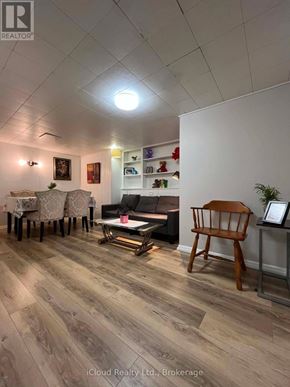St. Catharines (Burleigh Hill) apartment for rent - A living room with a wooden floor and a white wall.