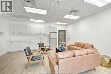 Amherstburg apartment for rent - A living room with a brown couch and a chair.