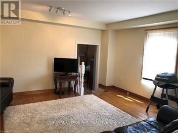 Niagara-On-The-Lake (Town) apartment for rent - A living room with a television and a grill.