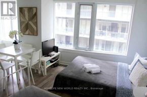 Toronto (Church-Yonge Corridor) condo for rent - A bedroom with a bed, a table, chairs, and a window overlooking a balcony.