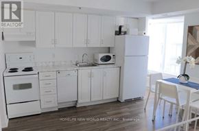 Toronto (Church-Yonge Corridor) condo for rent - A white kitchen with a refrigerator, microwave, and oven.