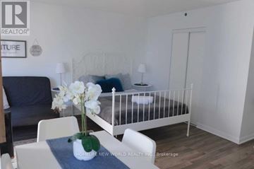 Toronto (Church-Yonge Corridor) condo for rent - A white bedroom with a white bed and a white chair.