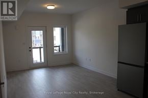 Guelph (Clairfields/Hanlon Business Park) townhouse for rent - A white room with a door and a window.