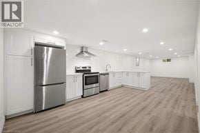 Kitchener apartment for rent - A well-lit kitchen with wooden floors and stainless steel appliances.