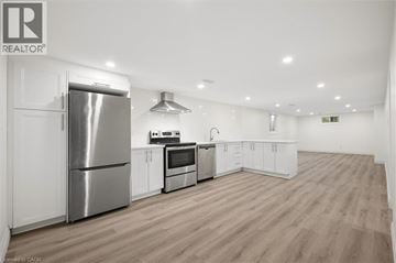 Kitchener apartment for rent - A well-lit kitchen with wooden floors and stainless steel appliances.