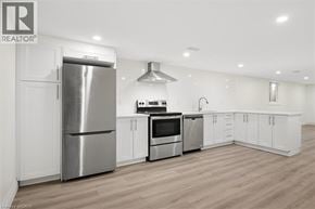 Kitchener apartment for rent - A modern kitchen with a stainless steel refrigerator, oven, and microwave.