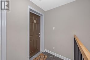 Ottawa condo for rent - A brown door with the number 8 on it is in a room with white walls.