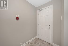 Ottawa condo for rent - A white door in a room with a brokerage sign on the wall.