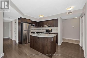 Ottawa condo for rent - A kitchen with a stainless steel refrigerator and wooden cabinets.