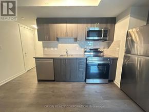 Toronto (Yorkdale-Glen Park) condo for rent - A kitchen with a refrigerator, oven, and microwave.