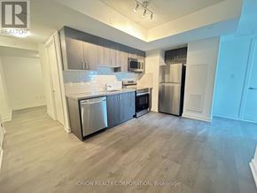 Toronto (Yorkdale-Glen Park) condo for rent - A kitchen area with a refrigerator, oven, and microwave.