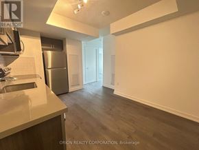 Toronto (Yorkdale-Glen Park) condo for rent - A kitchen with a refrigerator, sink, and cabinets.