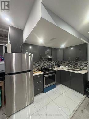 Brampton (Northwest Brampton) apartment for rent - A modern kitchen with a stainless steel refrigerator and marble countertops.