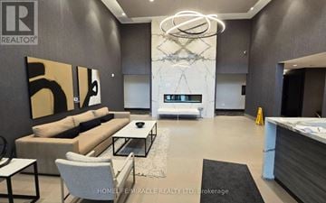 Milton (Walker) condo for rent - A modern living room with a large sofa and a coffee table.