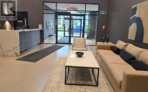 Milton (Walker) condo for rent - A reception area with a white reception desk and a beige sofa with a coffee table in the middle.