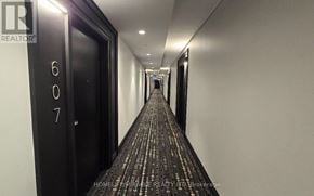 Milton (Walker) condo for rent - A hallway with a carpeted floor and doors on the left side.