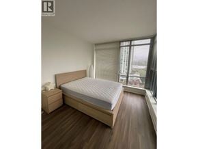 Coquitlam apartment for rent - A bedroom with a large bed and a nightstand.