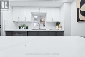 Toronto (Banbury-Don Mills) condo for rent - A modern kitchen with white cabinets and a marble countertop.
