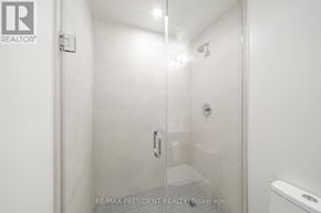 Toronto (Waterfront Communities) condo for rent - A glass shower door in a white bathroom.