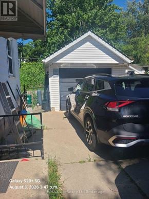 Woodstock (Woodstock - South) apartment for rent - A black SUV is parked in front of a white garage.