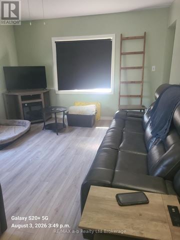 Woodstock (Woodstock - South) apartment for rent - A living room with a black leather couch and a flat screen TV.