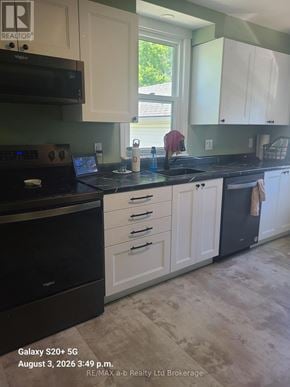Woodstock (Woodstock - South) apartment for rent - A kitchen with a black stove top oven and white cabinets.